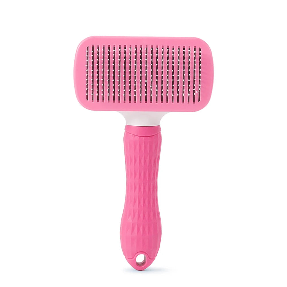 A pink pet hair removal brush with massage pins and a white handle.