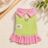 A pink and lime green short-sleeved dress for a child with a collar and ruffle detail.