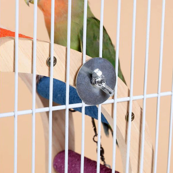 A parrot is climbing a wooden ladder toy inside a wire cage.