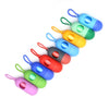 A line of colorful capsule-shaped dog poop bag dispensers with carabiner clips.