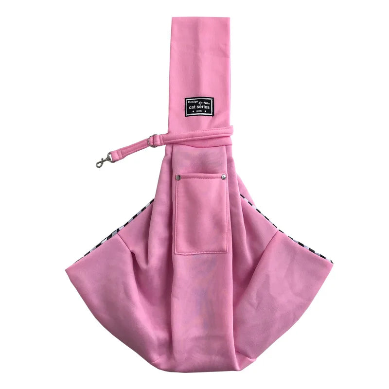 A pink pet carrier sling bag designed for dogs and cats with a flap closure.