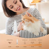 A woman is holding an orange and white cat while demonstrating a rechargeable pet paw trimmer for cats and dogs.
