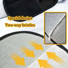 Close-up of a black reusable pet hair cleaning glove with two-way bristles on a light gray fabric background.