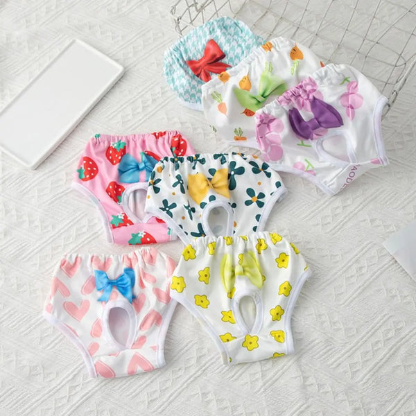 Une collection de pantalons physiologiques pour chiens réutilisables aux motifs floraux et colorés, présentés sur une surface