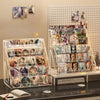 A clear acrylic display stand holds various business cards and brochures on a shelf.