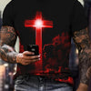 A man wearing a black t-shirt with a red cross design and flames, holding a smartphone.