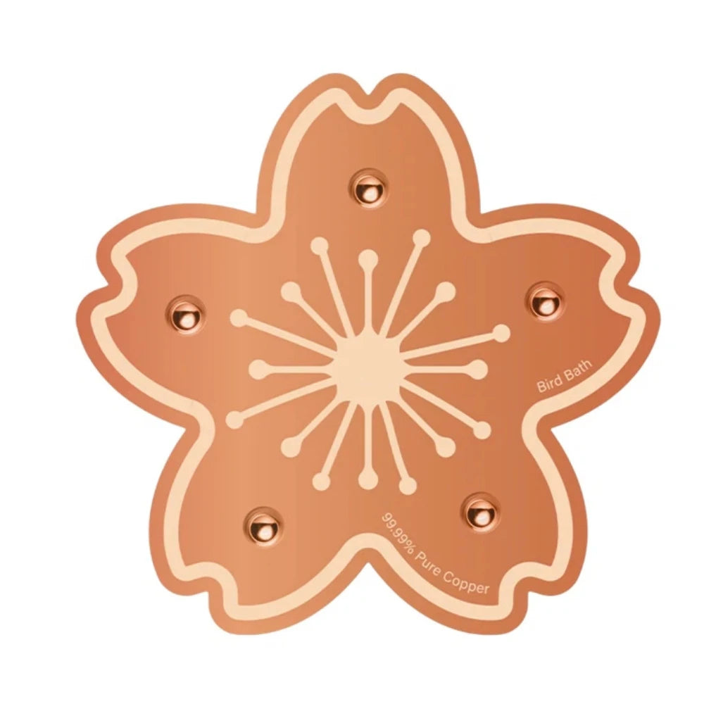 A round, fluted copper disc designed for a bird bath.