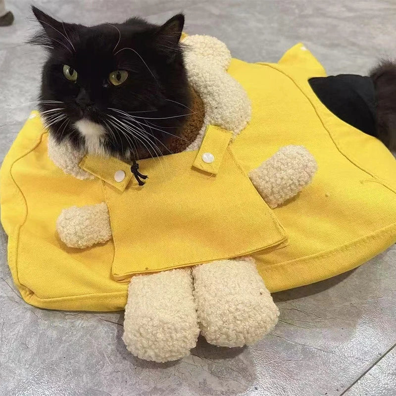A yellow breathable mesh pet carrier backpack with white fluffy paws is shown.