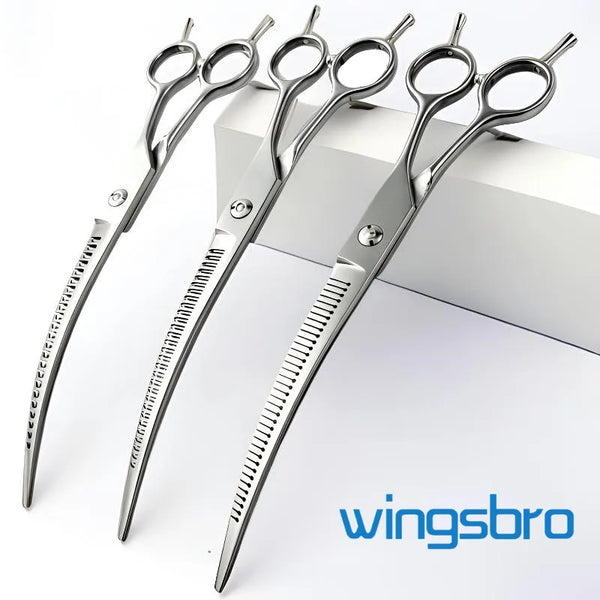 A pair of silver curved pet grooming scissors lying on a white surface.