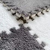 A close-up view of a gray cozy fleece pet warming mat with a textured surface.