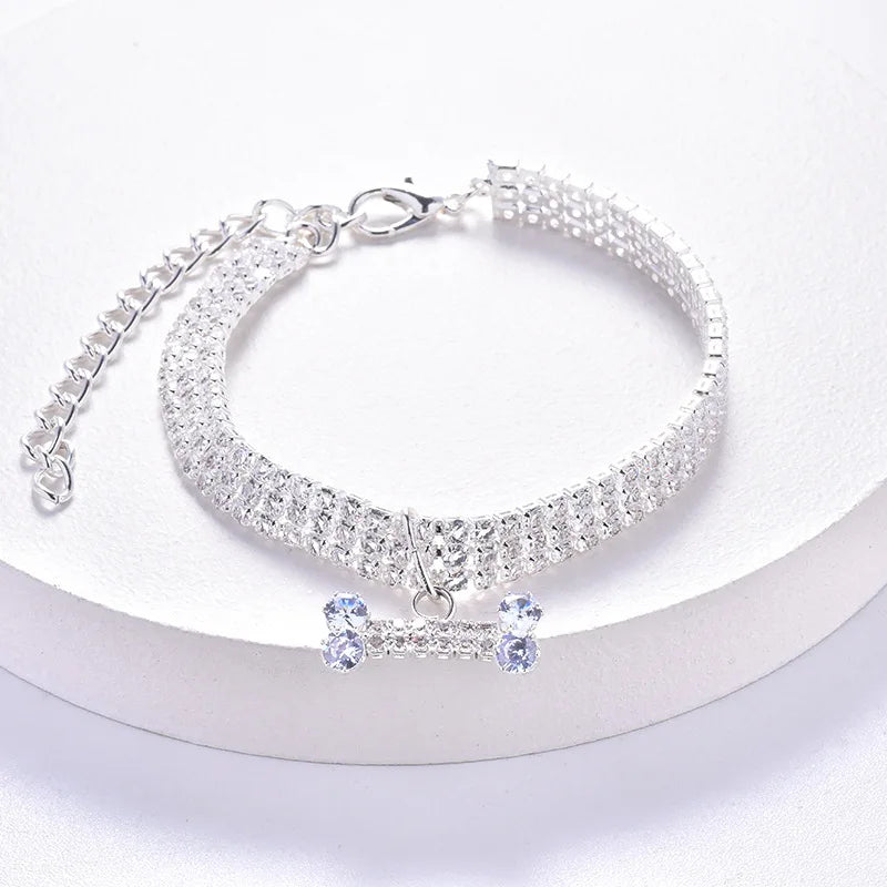 Silver crystal rhinestone pet collar with a bone pendant displayed on a white background