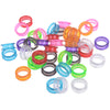 A collection of colorful silica gel hair scissors rings in various bright colors like pink, orange, green, and blue.
