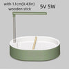 A light green automatic bird bathtub with a resting stick and power specifications 5V 5W
