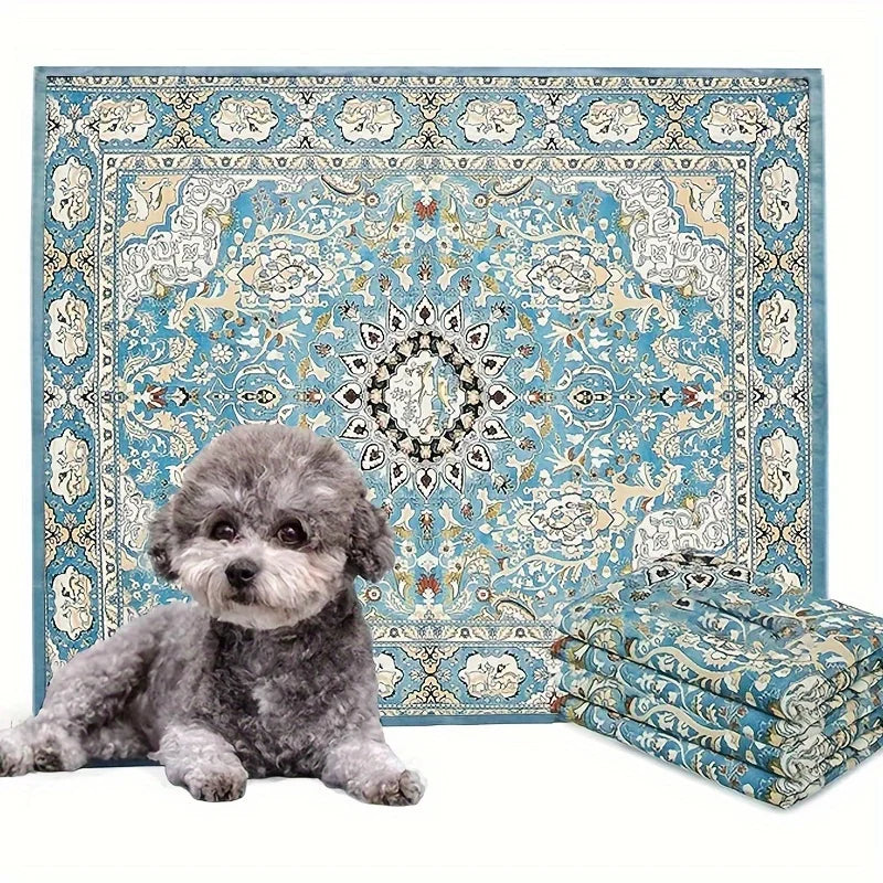 A fluffy gray dog is lying in front of a patterned blue and cream reusable dog pee pad.