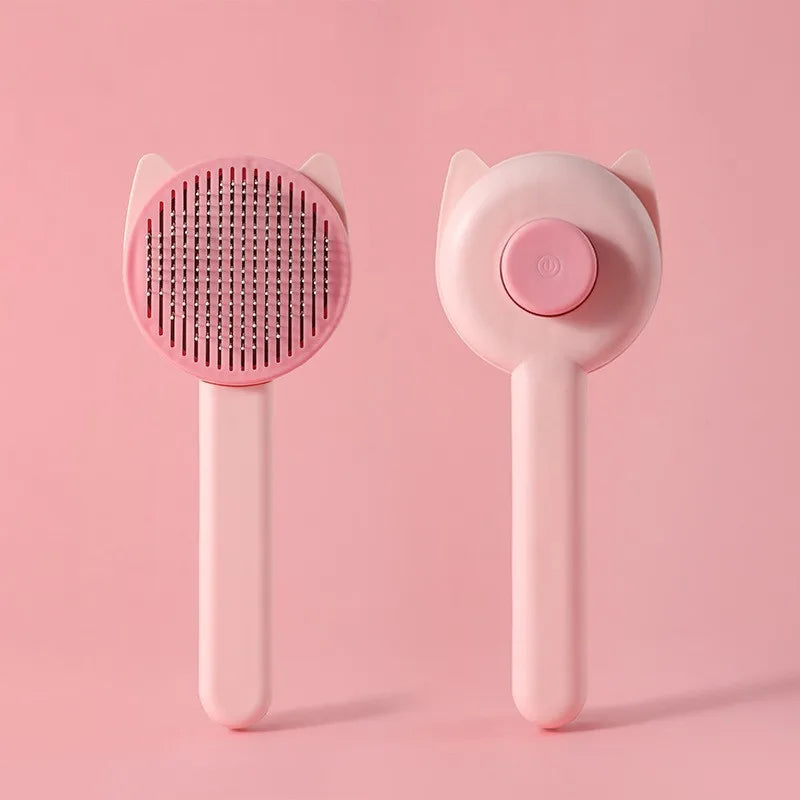 A pink one-button pet hair removal brush for cats and dogs shown against a light pink background.