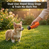 A person holds an orange ultrasonic device while a small dog looks toward it in a grassy outdoor setting.