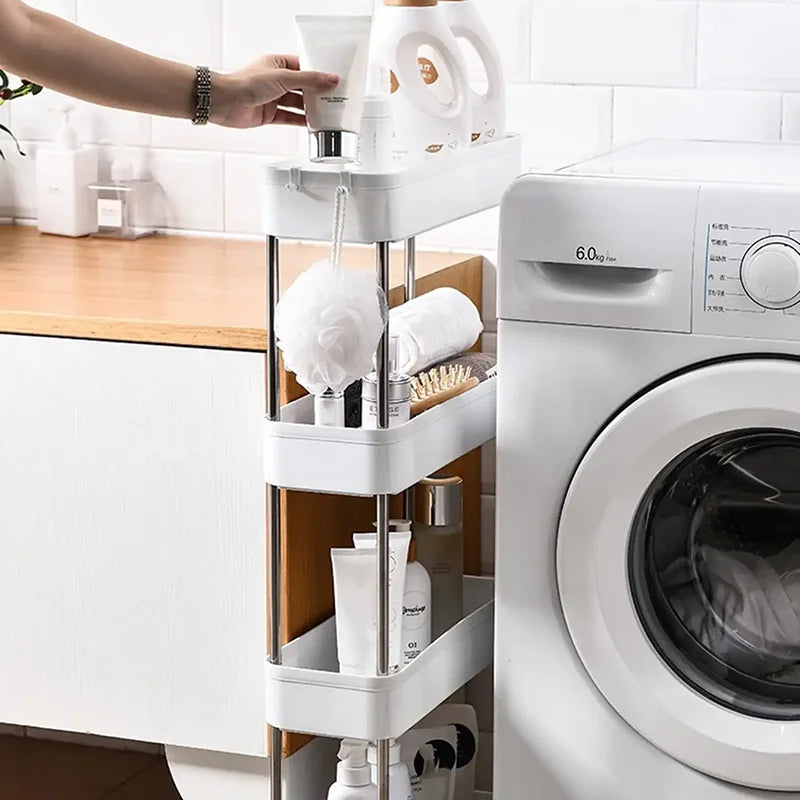 A white 3/4 tier mobile storage rack holding various beauty and personal care products near a washing machine.