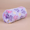 A soft purple fleece blanket featuring a paw print design in pink, yellow, and purple hues.