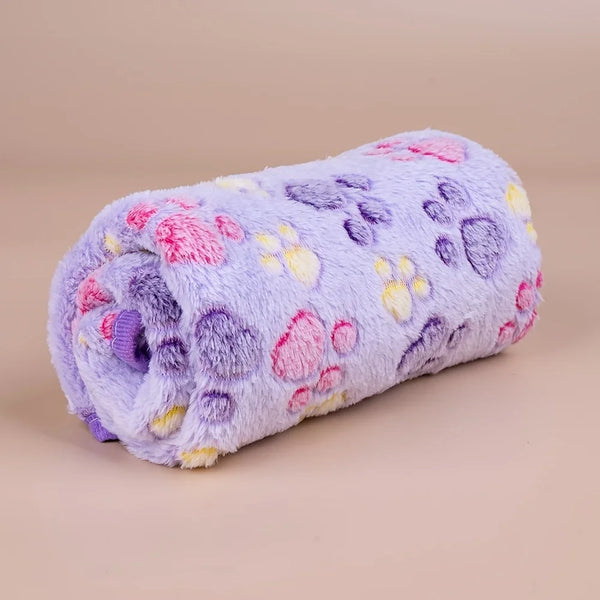 A soft purple fleece blanket featuring a paw print design in pink, yellow, and purple hues.