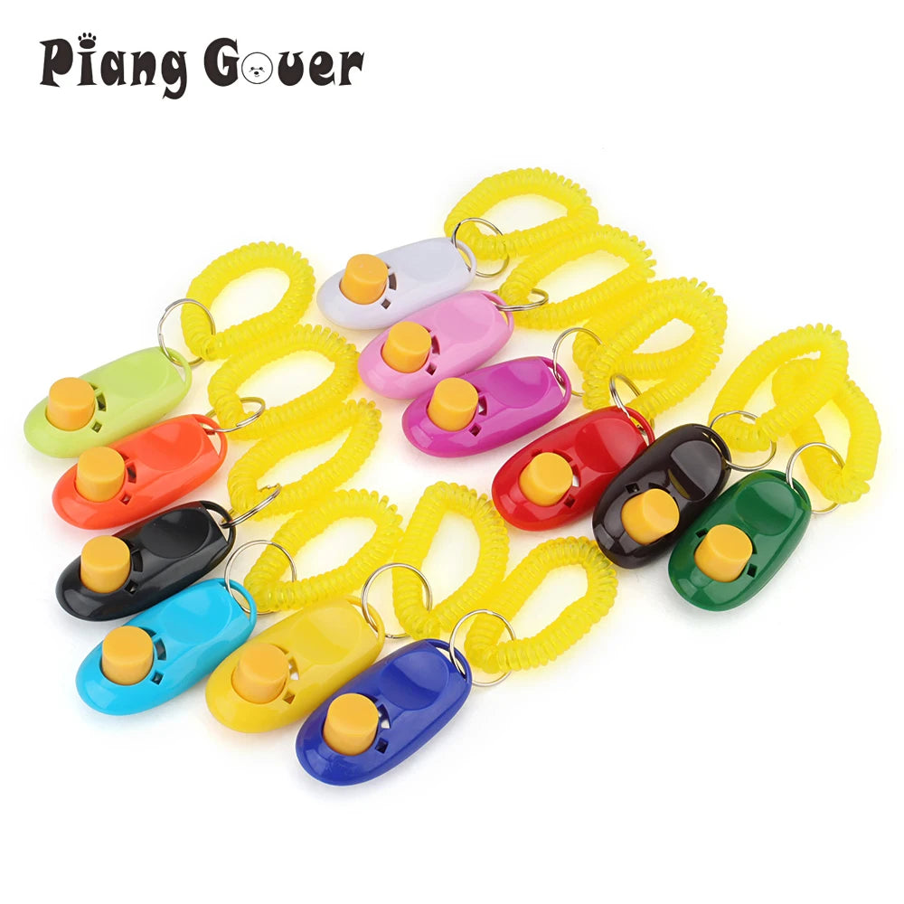 A collection of colorful dog training clickers and leashes with yellow elastic bands.