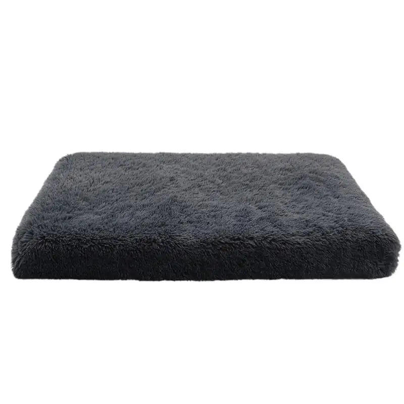 A rectangular, dark gray ultra plush orthopedic dog bed with a fluffy texture.