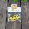 A clear plastic bag contains yellow clip-on bird cage feeder cups with mounting brackets and a happy bear sticker.