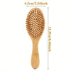 A wooden bamboo hair brush with massage bristles shown vertically, measuring 6.5cm wide and 21.5cm long.