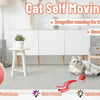 A gray cat is playing with an orange self-moving ball toy on a rug, demonstrating the interactive mode.