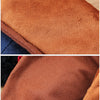 Close-up of a brown faux fur dog jacket showing the texture and stitching.