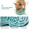 A cat is using a slow food design bowl for feeding, demonstrating the anti-gulping feature and maze pattern.