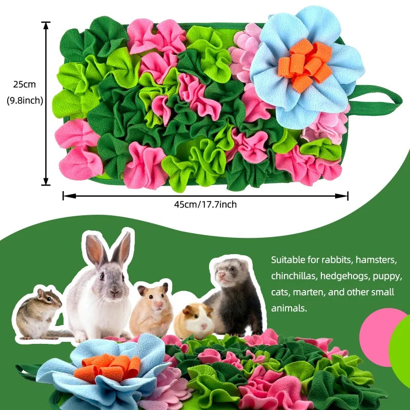 A green fabric mat with colorful, textured leaves and flowers designed for small animal foraging.
