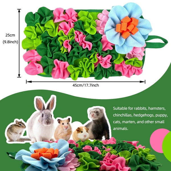 A green fabric mat with colorful, textured leaves and flowers designed for small animal foraging.