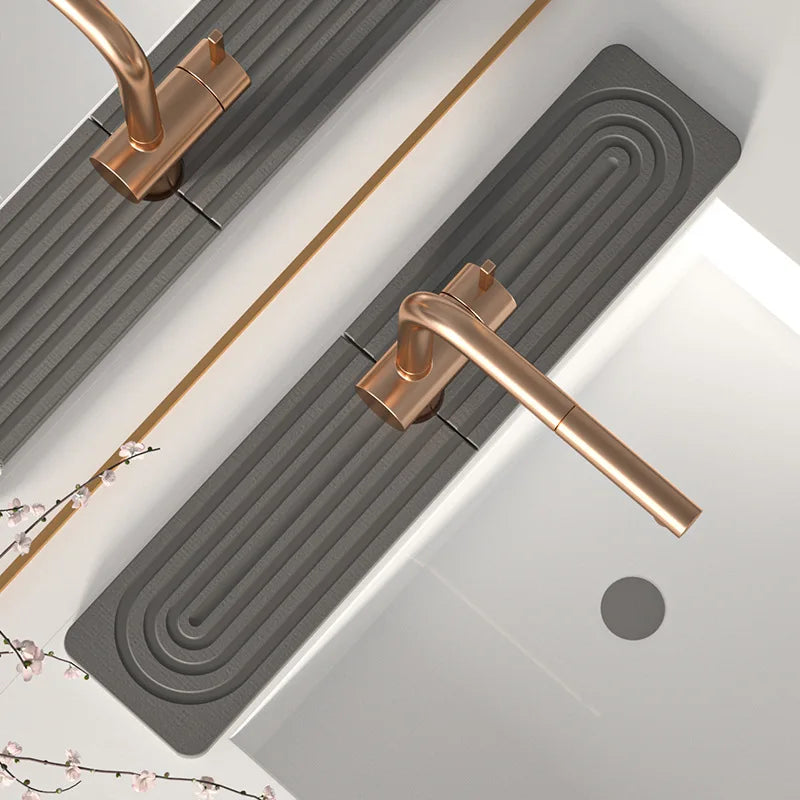 A brass diatomaceous earth absorbent mat installed horizontally in a bathroom or kitchen, featuring ribbed design.