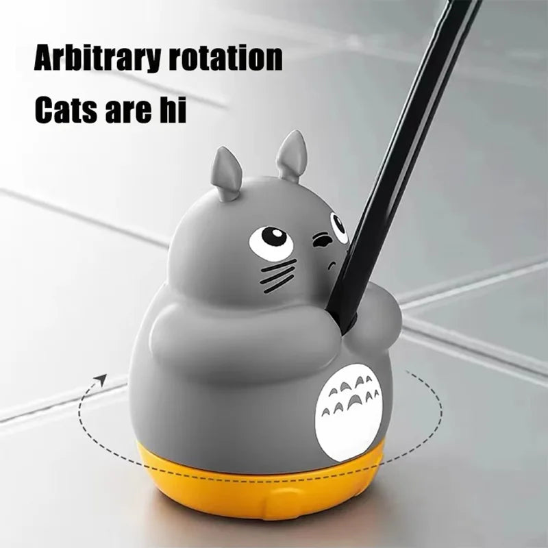 A gray cat-shaped toy wand with a black stick and an orange base is shown for arbitrary rotation play.