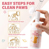 A hand is squeezing a white pump dispenser of pet paw cleaner foam for cats and dogs
