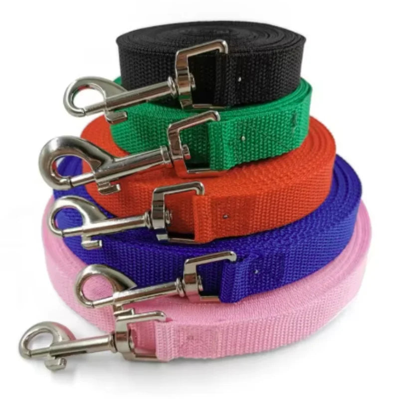 Stack of colorful durable nylon dog training leashes in black, green, orange, and purple.