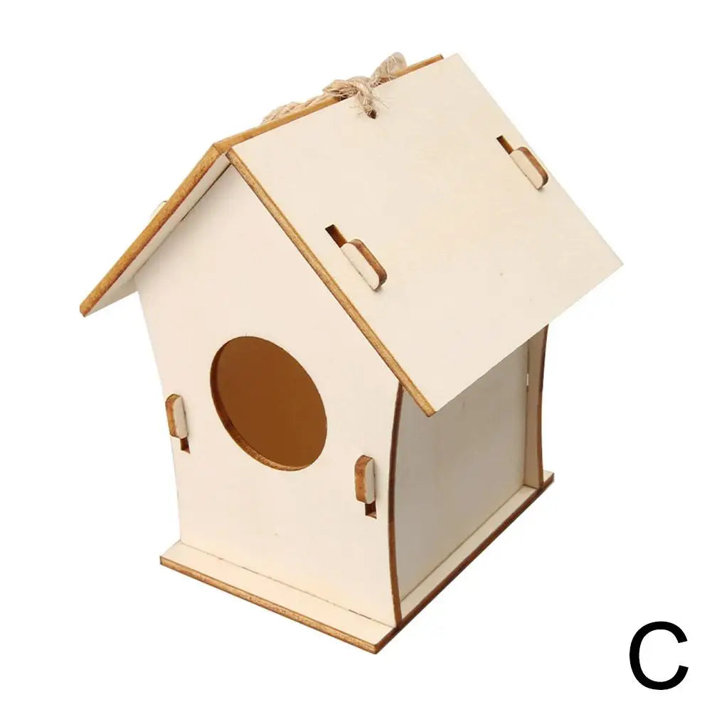 A small, unfinished wooden bird house with a pitched roof and an oval entrance, tied with hemp rope.