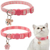 A pink aesthetic cat collar with a bow pendant shown next to a white cat.