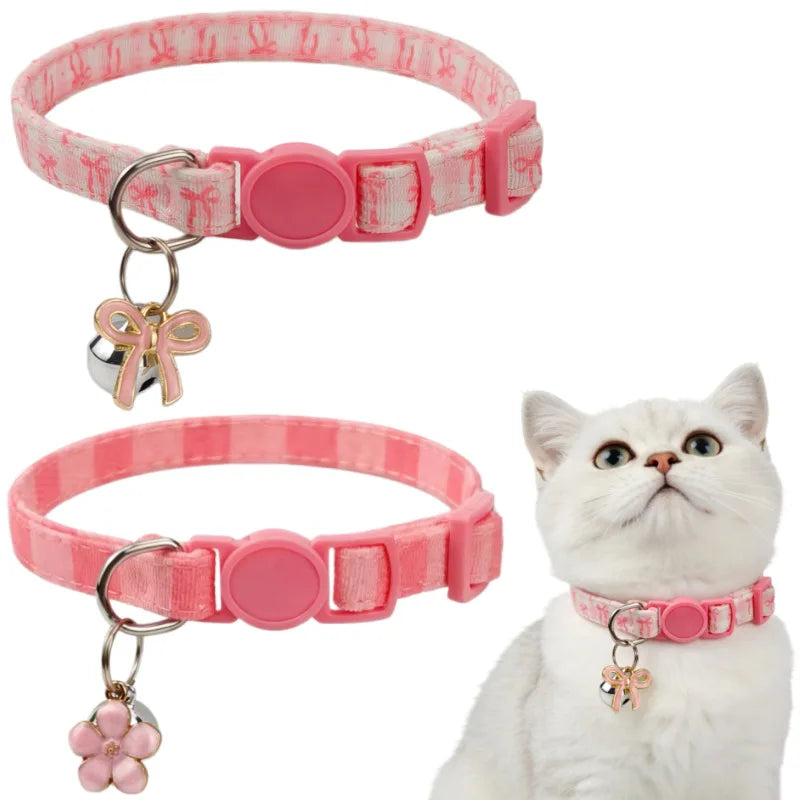 A pink aesthetic cat collar with a bow pendant shown next to a white cat.