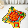A colorful, flower-shaped snuffle mat for dogs with various fabric textures and colors.