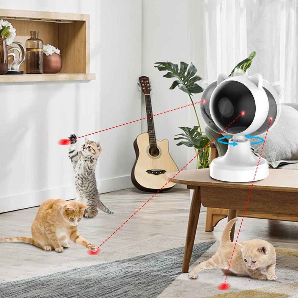 A cat playing with an automatic laser toy on a wooden table, demonstrating interactive play.