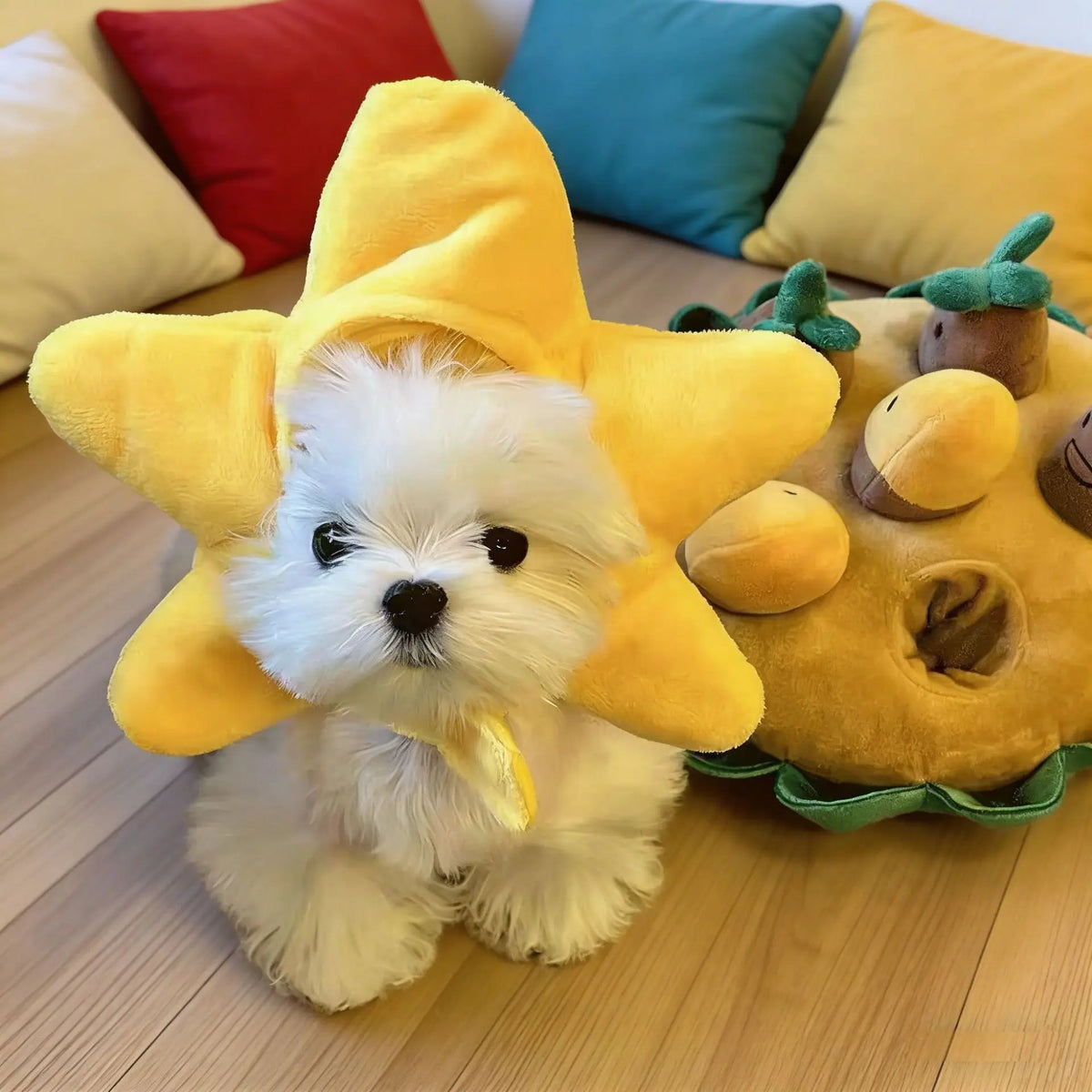 A fluffy white pet head cover shaped like a yellow flower, resting on a wooden floor.