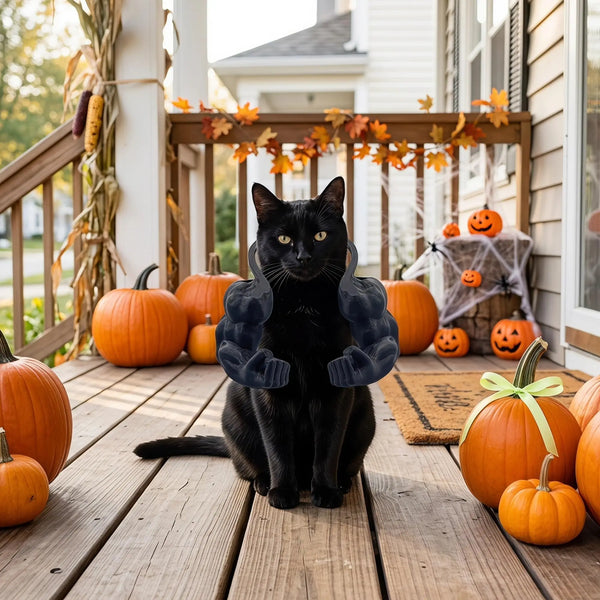 A black cat sitting on a wooden deck surrounded by orange pumpkins.
