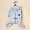 Light blue waterproof reflective dog raincoat and jumpsuit hanging on a hook