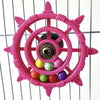 A pink interactive parrot spinner rattle toy with multiple colored balls inside a circular frame.