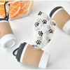 A set of portable pet poop trash can dispensers in beige and white colors.