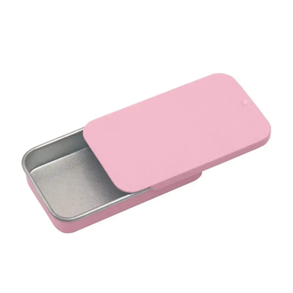 A pink compact sliding lid tin box for storing treats, pills, and small items.