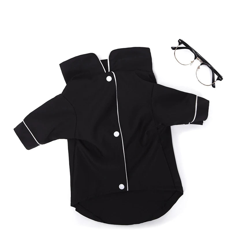 Black luxury silk pet pajamas for a small dog lying flat.