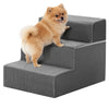 A fluffy orange dog is standing on a gray, textured pet climbing stairs ramp.