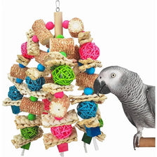 A colorful wooden parrot bite toy made of various textures and colors hanging from a wooden dowel.